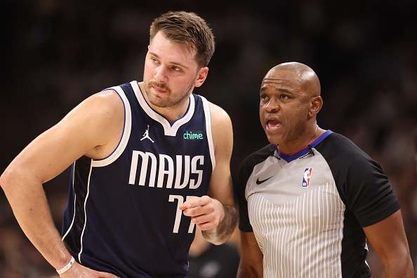 Dallas Mavericks superstar Luka Doncic talking with an official.